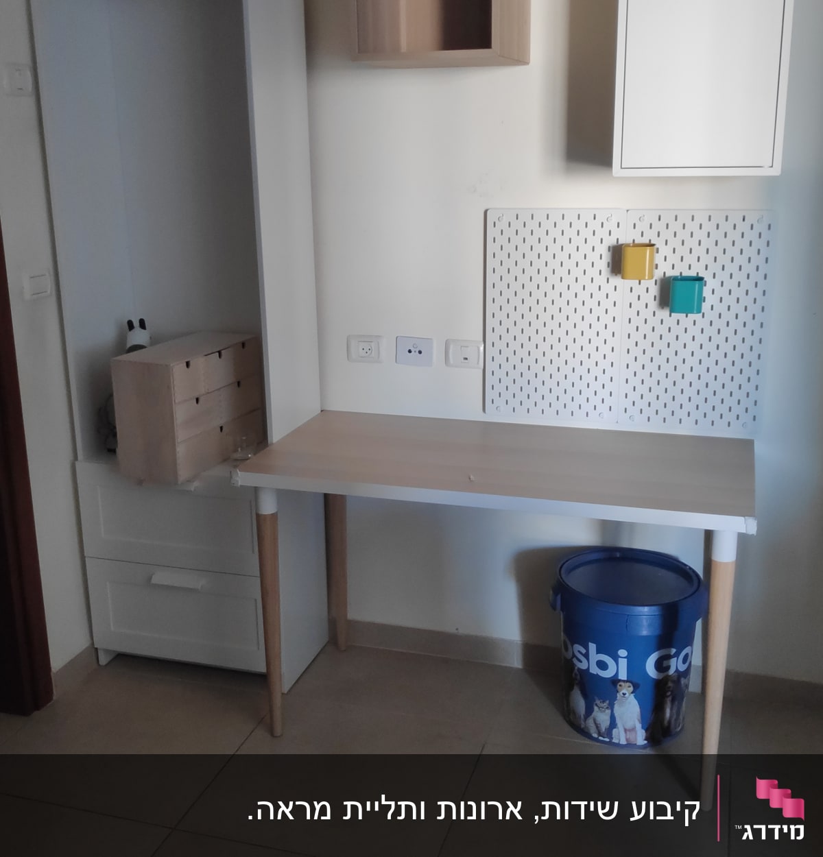 שולחן עבודה עם לוח כלים וקופסאות צבעוניות